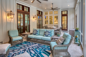Tabby concrete floors, mahogany doors. A screened porch with white board and batten walls and a tabby concrete floor with areas for sitting and dining.
