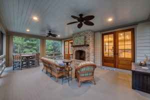Brick fireplace and mahogany doors. A second floor screened porch with a sitting area and a brick fireplace.