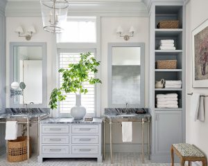 Elegant bathroom with double vanities, marble countertops, and soft gray cabinetry in a Palmetto Bluff residence.